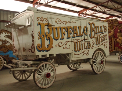 [White wagon (including wheels) with name of show painted in large gold letters on the side.]